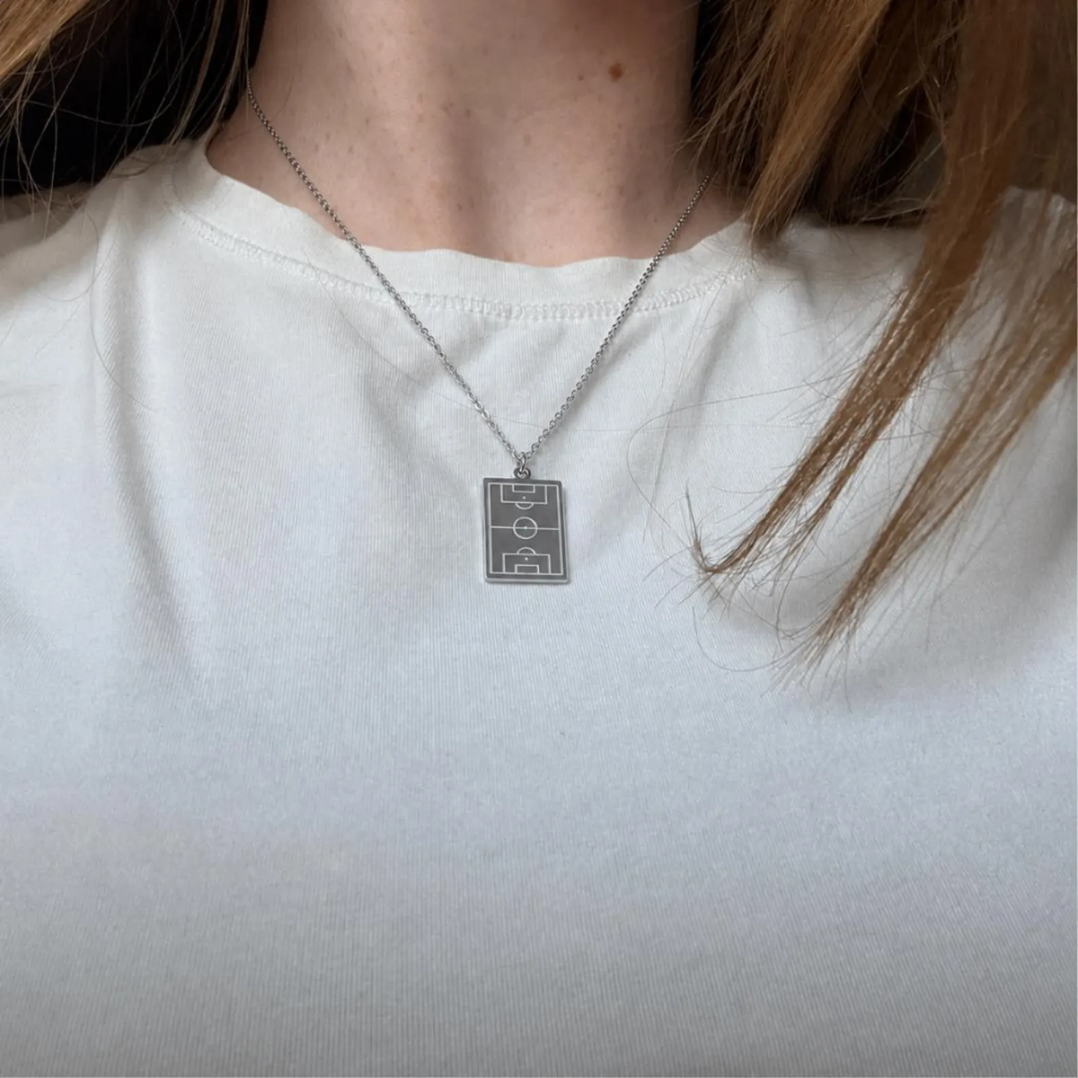 Silver Soccer Field Necklace worn with a white top