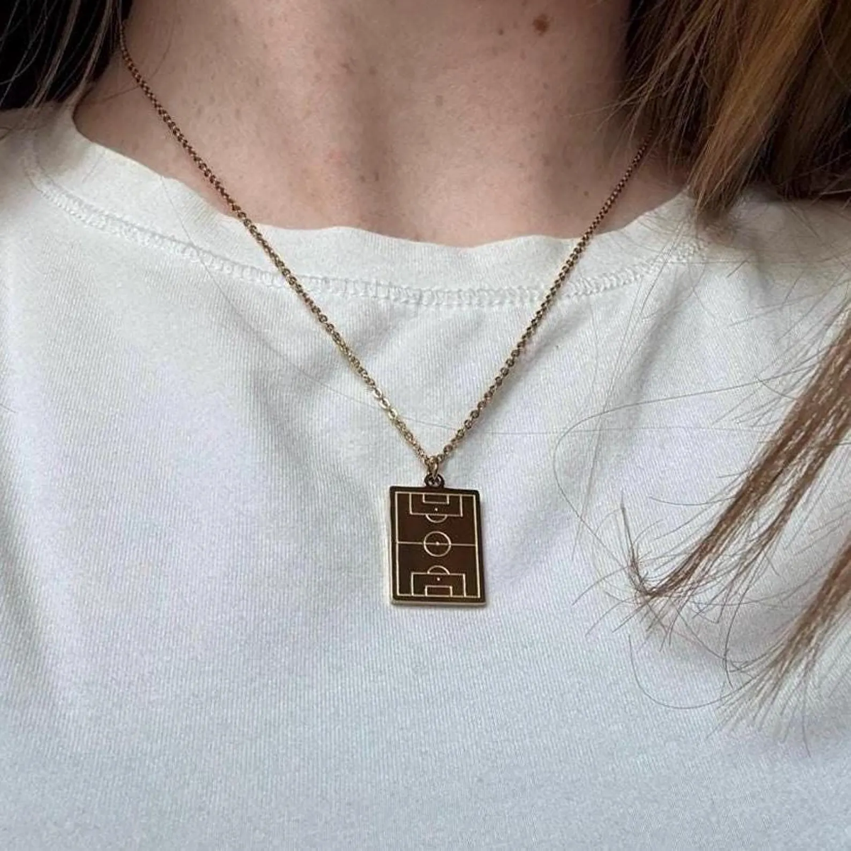 Gold Soccer Field Necklace worn with a white top
