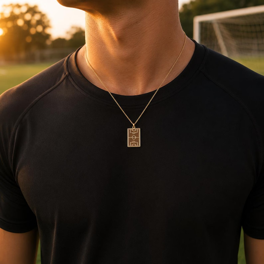 Gold Soccer Field Necklace worn with a black training top on a football pitch