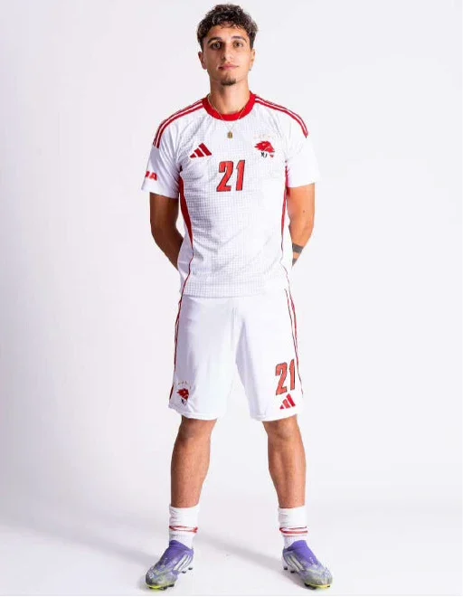 Soccer player in a white number 21 kit