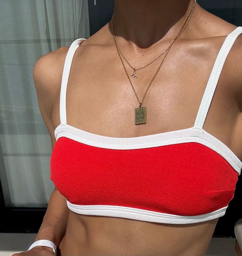 Athlete wearing a layered pitch pendant