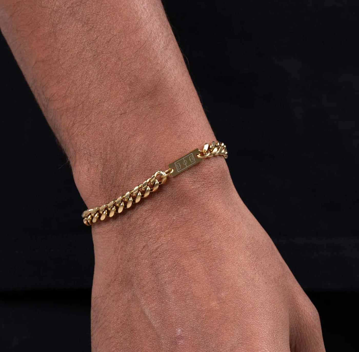 Gold soccer bracelet on the wrist