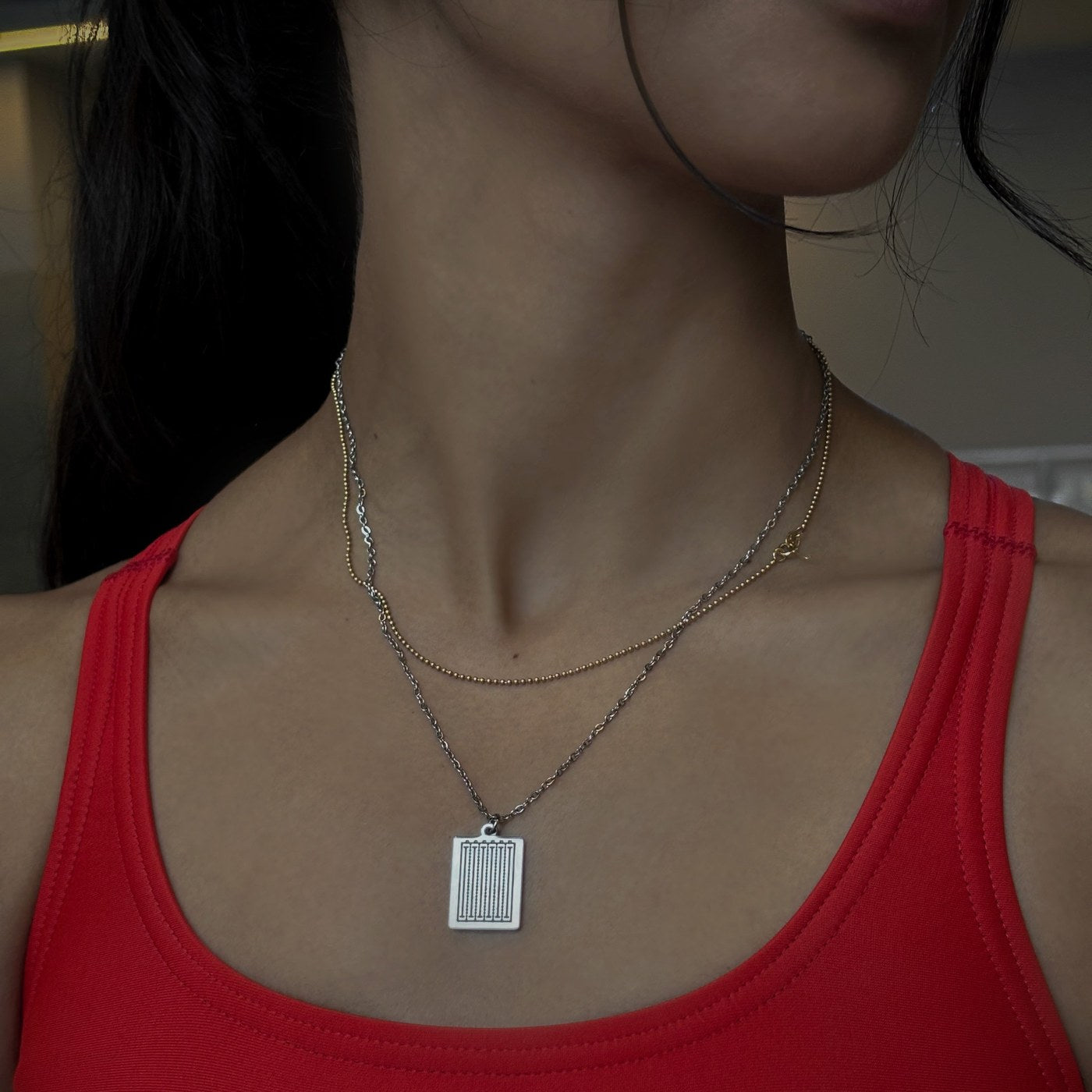 Silver swimming pendant worn