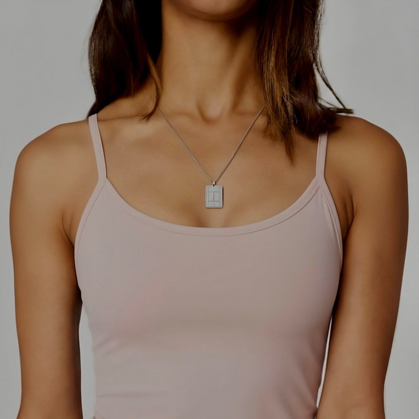 Silver tennis court pendant worn